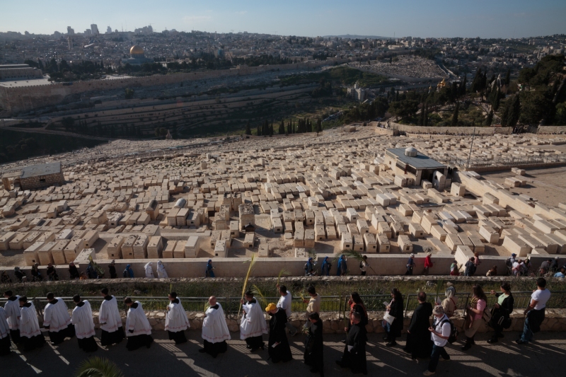 A group of Christian pilgrims walk down the Mt of Olives in Jerusalem on Palm Sunday. March 24, 2013.  