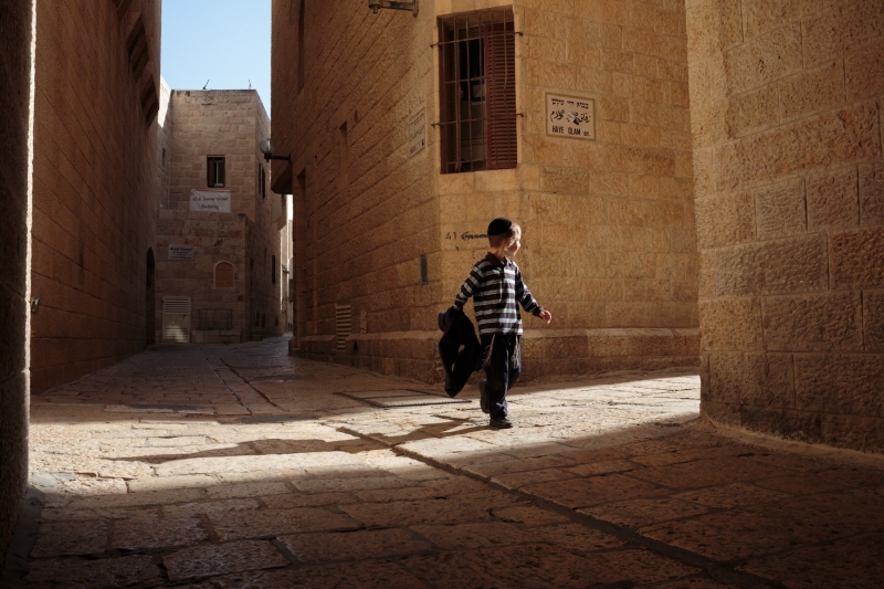 A young Jewish boy runs through the streets of the Old City in Jerusalem on April 3, 2013.  